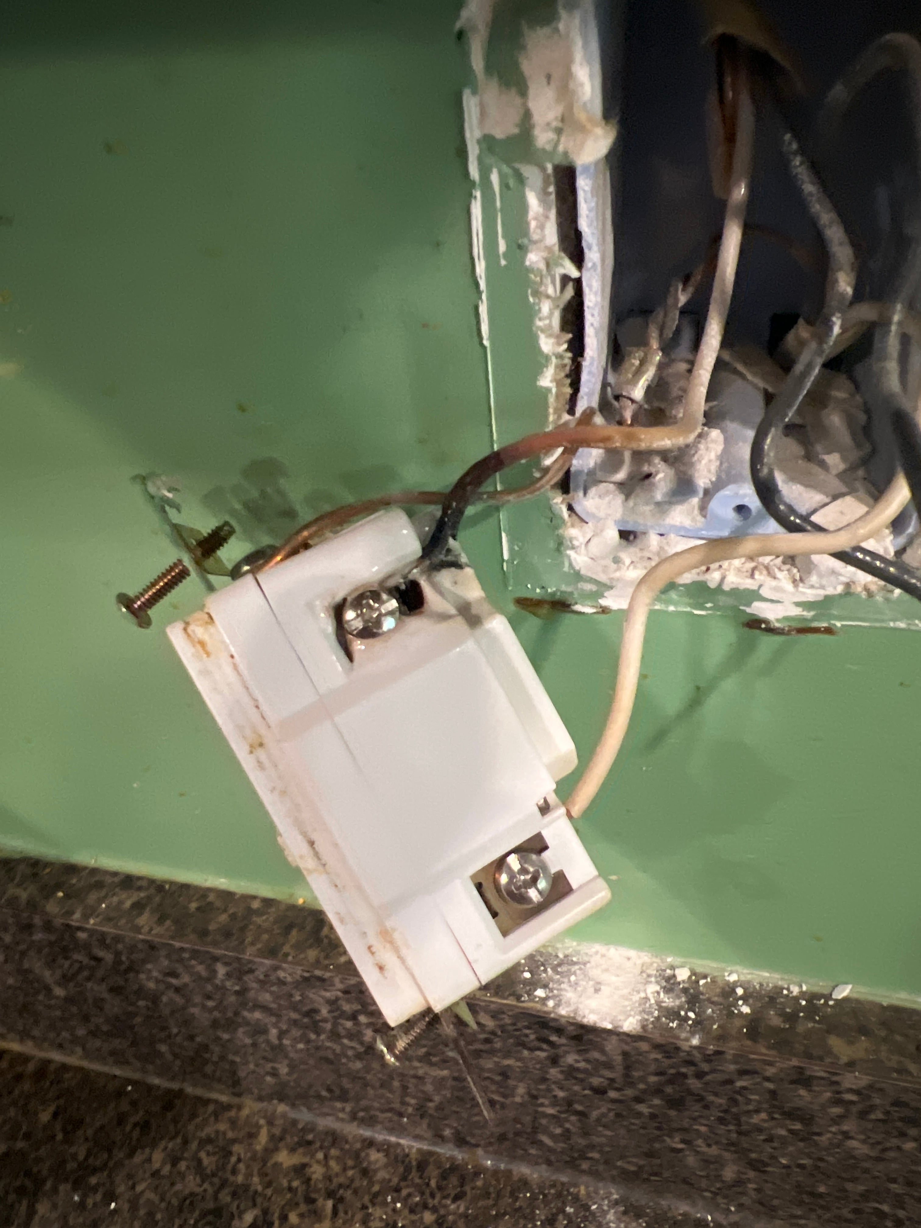Newly installed GFCI outlet with wiring connections visible
