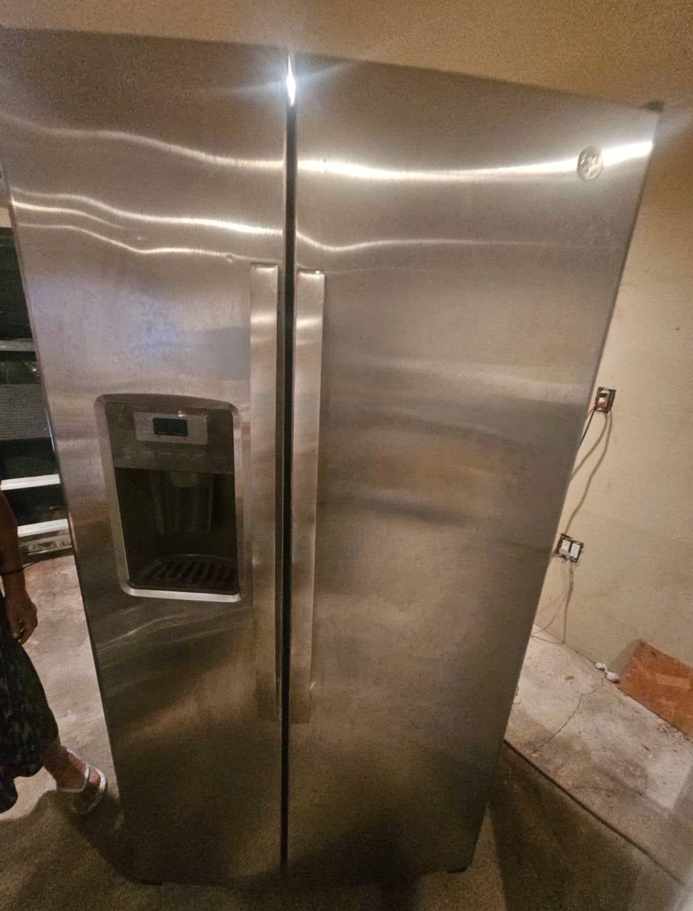 GE refrigerator interior showing dispenser control board and ice chute door assembly